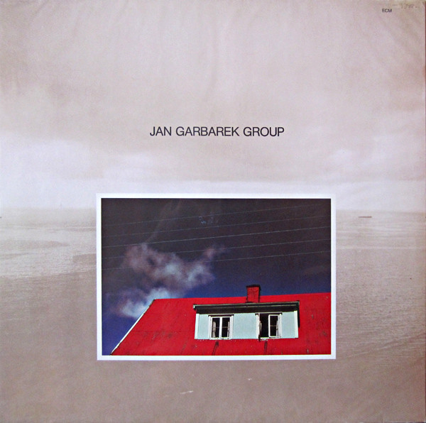 Jan Garbarek Group — Photo with Blue Sky, White Cloud, Wires, Windows and a Red Roof
